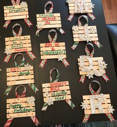 several wooden signs with ribbons and snowflakes on them are arranged in the shape of letters