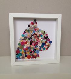 a white frame with buttons in the shape of a christmas tree