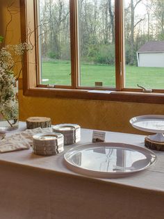 the table is set up with plates and silverware for guests to enjoy their meal