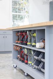 a workbench with lots of tools on it in a room filled with cabinets