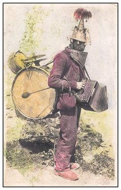 an old photo of a man with a weird hat holding a musical instrument and drum