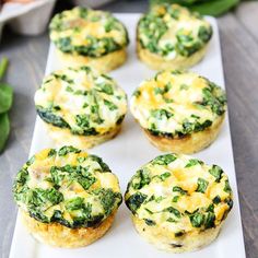 small muffins with spinach and cheese on a white plate