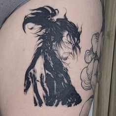 a woman's thigh with a black and white drawing of a girl on it