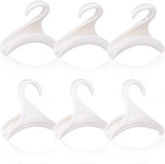 six pairs of white plastic hangers