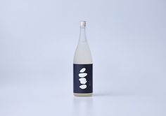 a bottle of liquid sitting on top of a white table