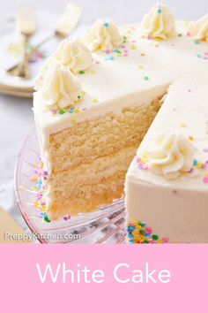 a cake with white frosting and sprinkles on it