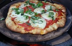 a pizza sitting on top of a metal pan