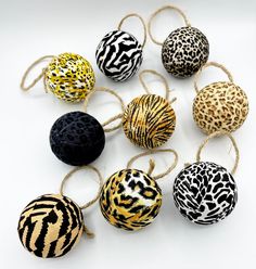 several different types of balls tied together on a white surface with black and yellow designs