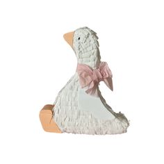 a white duck with a pink bow on its head sitting in front of a white background