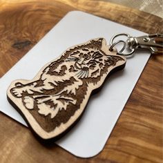 a wooden keychain with a tiger design on it