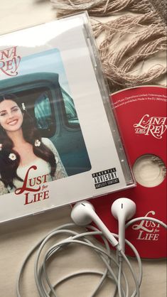 a cd and headphones sitting on top of a table