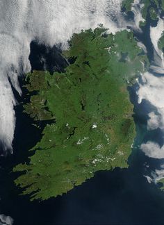 an island in the ocean surrounded by clouds and water, as seen from space on a satellite camera