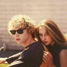 a young man and woman sitting next to each other