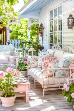 a white couch sitting on top of a wooden floor next to a pink coffee table