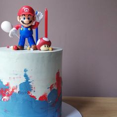 a birthday cake decorated with an image of mario and mushroom