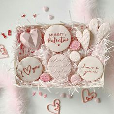 a box filled with lots of decorated cookies