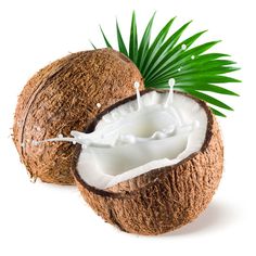 coconuts with milk in the middle and green leaves on top, against a white background