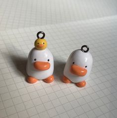 two small plastic ducks sitting next to each other