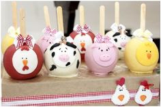 there are many farm animals on sticks in the shape of eggs with faces painted on them