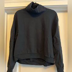 Mock Neck. Cropped Fit In Front. Never Been Worn. New With Tags. Soft A&F Collection Black Funnel Neck Sweater For Layering, Black Crew Neck Top With Ribbed Collar, Black Tops With Ribbed Collar For Loungewear, Black Top With Ribbed Collar For Loungewear, Black Cotton Top With Ribbed Collar, Black Cozy Crew Neck Top, Black Cozy Fit Crew Neck Top, Black Cotton Turtleneck Sweater, Casual Black Turtleneck For Layering