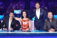 three men and a woman sitting at a table in front of a microphone on the set of dancing with the stars