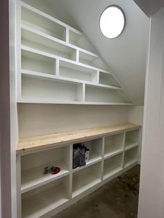 an empty room with shelves and lights in it