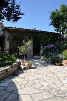 an outdoor patio with stone walls and plants