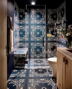 a bathroom with blue and white tiles on the walls