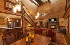 a living room filled with furniture and a fire place in the middle of a room