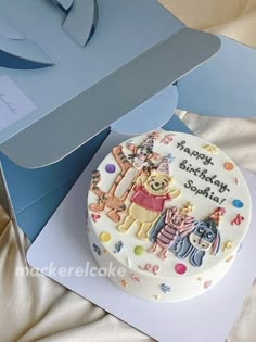 a winnie the pooh birthday cake in a box