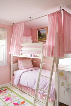 a white bunk bed sitting next to a pink curtained window in a child's room