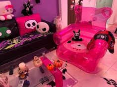 a living room filled with lots of furniture and pink decorations on top of the floor