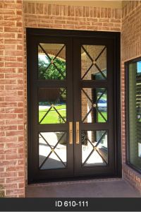 a black double door with glass panels and sidelights on the outside of a brick building