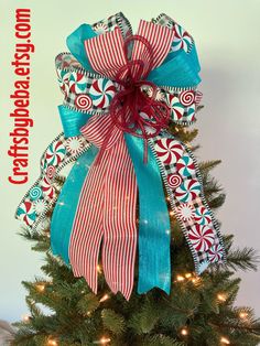 a christmas tree decorated with red, white and blue ribbons