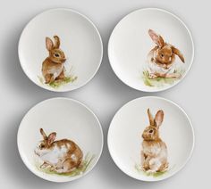 four plates with rabbits painted on them