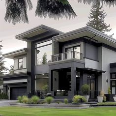 a large modern house with lots of windows and balconies on the second floor