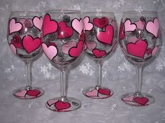 three wine glasses with hearts painted on them