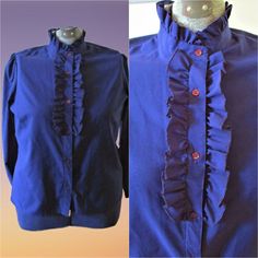 This is a fabulous Vintage Blouse 60's 70's Button Down Ruffle Navy Blue Blouse Shirt The Traveler By Connie Vintage Clothing.  Vintage Clothing The color and detail is just fabulous. Please see photos for they are the best description. Fit: Please note, item measurements are approximate and in the photos. Please compare measurements to your favorite garments to ensure fit. My Dress form is full figure. Sleeve length 23 inches Neck 16 inches length 26 inches Bust  41 inches Shoulder to shoulder is 16 inches Hip size 41 inches Thank you, so much, for taking the time to stop by my shop, and Please ENJOY!! I ship worldwide I try to describe items to the best of my knowledge, but I never claim to be an expert. Please study the pictures carefully and feel free to ask questions. I always combine Blue Ruffled Shirt For Fall, Blue Collared Blouse With Ruffles, Retro Blue Blouse With Buttons, Blue Retro Blouse With Buttons, Blue Ruffled Collared Blouse, Blue Collared Ruffle Top, Blue Vintage Blouse With Collar, Vintage Blue Button-up Denim Top, Blue Vintage Top With Button Closure