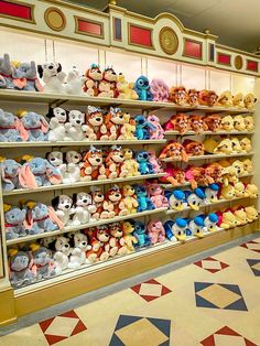 many stuffed animals are on display in the store's shelving area, including winnie the pooh