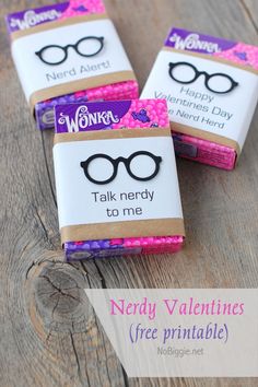 three nerdy valentine's candy wrappers on a wooden table