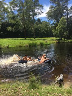 three people are in the water on rafts