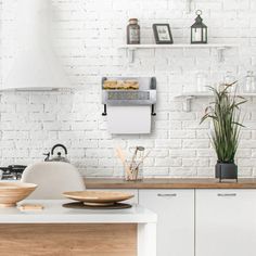 a kitchen with white brick walls and wooden counters