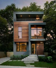 a modern house with stairs leading up to the second floor and two storyed windows