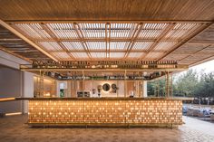 the inside of a restaurant with wooden walls and flooring is lit up by lights