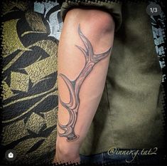 a man's arm with a tattoo on it that has a deer antelope