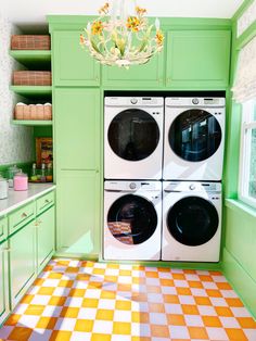 a green kitchen with checkered flooring and white washer and dryer combo