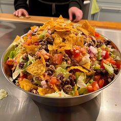 a large bowl filled with lots of taco salad