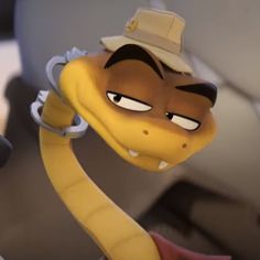 a cartoon snake wearing a hat and holding onto a pair of scissors in front of him