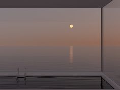 the moon is reflected in the window of an empty room overlooking the ocean at sunset