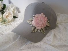 "I designed this adorable grey Youth Toddler baseball cap with a beautiful embroidered Pink Flower. This hat is so cute. These hats are really nice quality. Inside dimensions is approximately 20\" the velcro strap will add 3\" larger or smaller. velcro pony tail back These hats are washed cotton twill. see more youth toddler cadet and baseball hats here: https://www.etsy.com/shop/theraggedyrose?ref=seller-platform-mcnav&section_id=21134612 CUSTOM ORDERS ALWAYS WELCOME.... Will ship in 1 to 2 Adjustable Brimmed Gray Baseball Cap, Gray Snapback Hat For Spring, Gray Cap For Spring, Gray Spring Cap, Gray Brimmed Baseball Cap, One Size Fits Most, Gray Baseball Cap For Spring, Gray Curved Brim Baseball Cap For Spring, Gray Cotton Baseball Cap For Spring, Spring Gray Cotton Baseball Cap